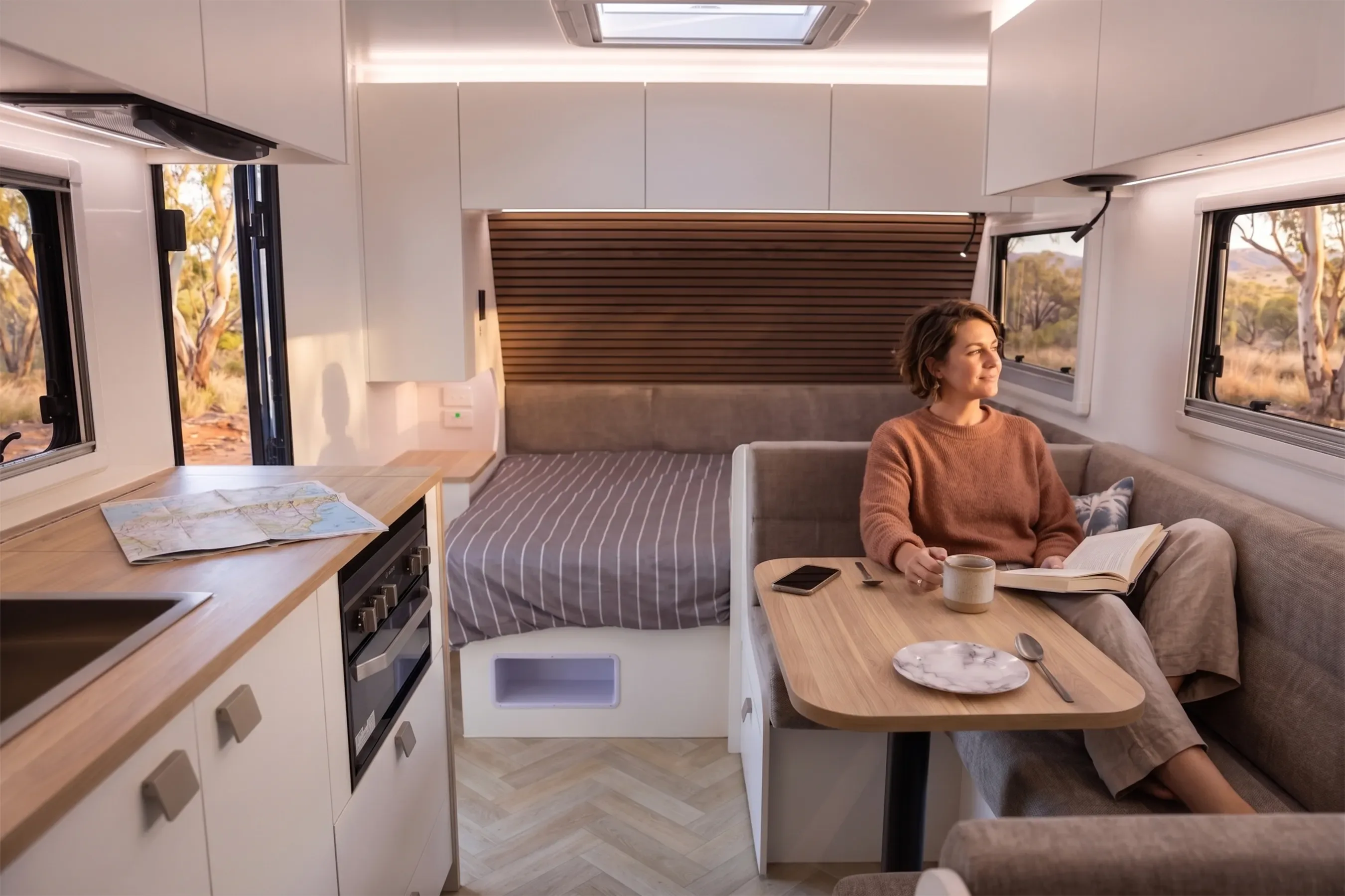 New Age Road Owl family interior with kitchen, club lounge and rear bed under a timber slat wall